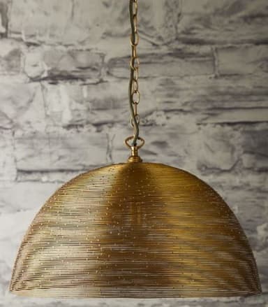 A dome-shaped pendant light featuring a shade constructed from tightly coiled or woven brass-toned metal wire. The wire creates a semi-transparent, textured surface that would diffuse light. The fixture is suspended by a matching metal chain, leading up to a ceiling mount (not fully visible). The metallic finish appears to be an aged or antique brass. — 3D model