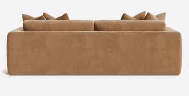 A contemporary tan-colored upholstered sofa featuring a minimalist design, track arms, and plush loose back cushions. — 3D model