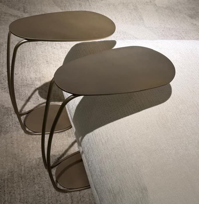 A modern side table with a tiered design. It features three organically shaped surfaces suspended by thin, curved metal legs. The surfaces are flat and appear to be made of a solid material. The overall structure is lightweight and abstract. — 3D model