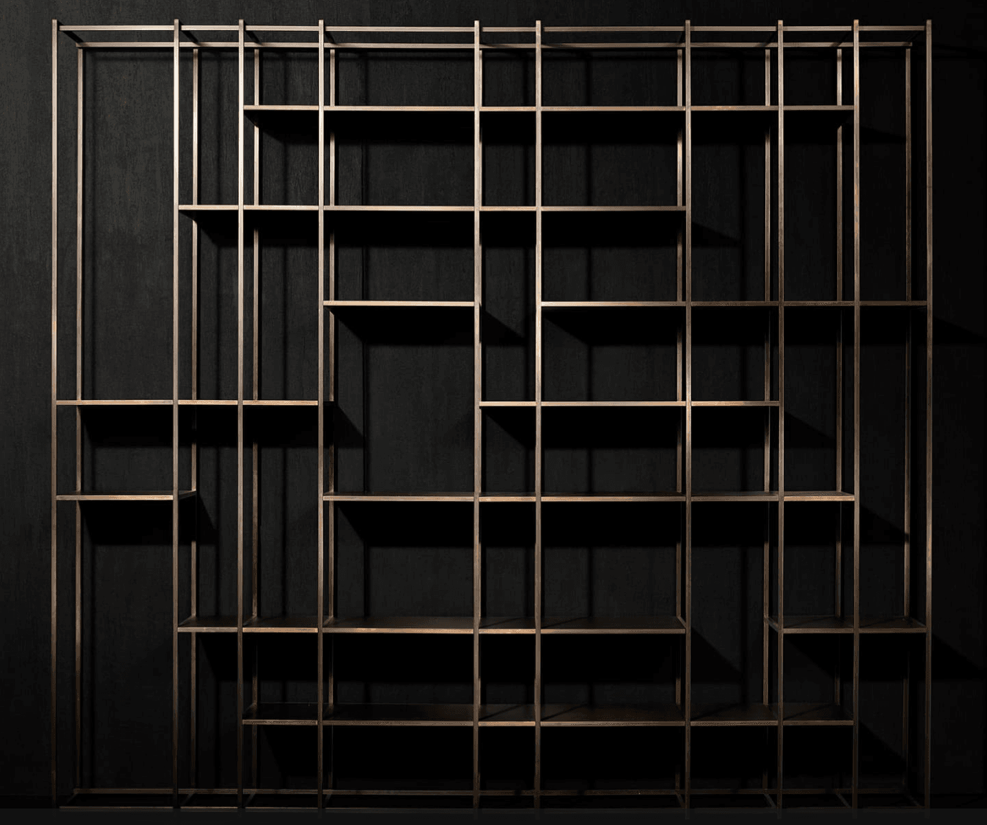A modern, open-frame shelving unit crafted from bronzed metal, featuring a geometric arrangement of shelves within a rectangular framework. The unit presents an asymmetric and dynamic visual structure, suitable for displaying various items. — 3D model