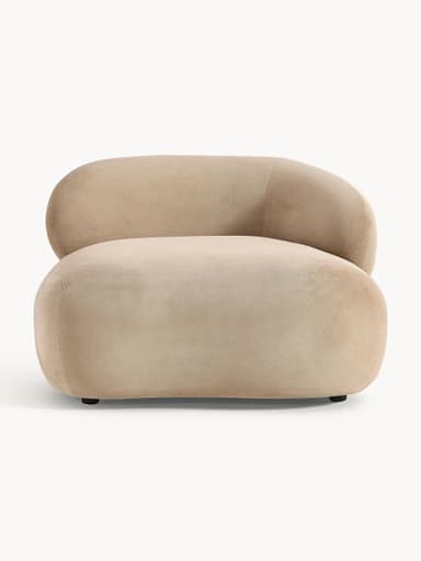 A contemporary armchair with a rounded, organic silhouette. It features a low profile with a deep seat and a single, curved armrest that seamlessly integrates into the backrest. The upholstery appears to be a soft, textured fabric. — 3D model