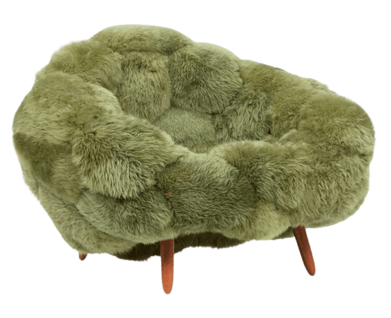 A plush, oversized armchair with a distinctive, organic, bulbous form. The upholstery appears to be made of a shaggy, long-pile faux fur or sheepskin in a muted olive green hue. The seat and back are not distinctly separated, creating a continuous, enveloping shape. The chair is supported by three short, tapered wooden legs with a natural finish. — 3D model