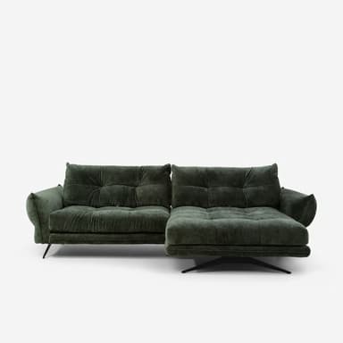 A modern sectional sofa upholstered in a textured dark green fabric. The sofa features deep tufting on the back cushions and seat cushions, creating a grid pattern. It has a chaise lounge on the right side and is supported by slender black metal legs with a distinctive angled design on the left, and a single sculptural metal base on the right. The armrests are wide and rounded. — 3D model