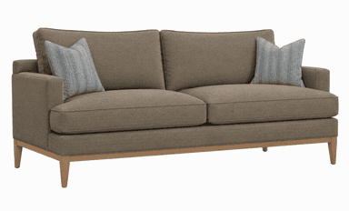 A contemporary two-seater sofa upholstered in a light brown, subtly textured fabric. It features a clean-lined silhouette with block arms and an exposed light wood frame base, including tapered legs. The sofa is furnished with two removable seat cushions and two back cushions, complemented by two light grey patterned throw pillows. — 3D model