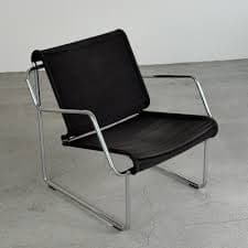 A modern lounge chair featuring a chrome-plated tubular steel frame and a black fabric sling for the seat and backrest. — 3D model