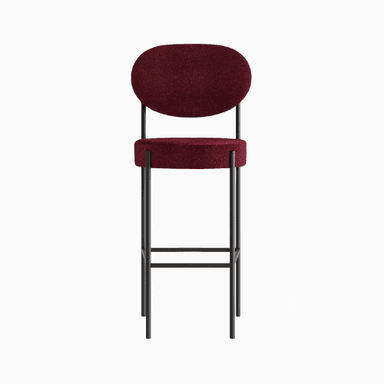 A modern bar stool with a minimalist design. It features a slender metal frame supporting a circular seat and an oval backrest, both upholstered in a textured, deep red fabric. The frame has a dark, matte finish, and the legs are connected by horizontal supports for stability. — 3D model
