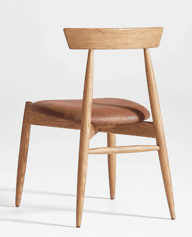 A modern dining chair constructed from light-toned oak wood with a brown leather upholstered seat. The chair features a minimalist design with tapered legs, a subtly curved backrest, and a sturdy wooden frame. — 3D model