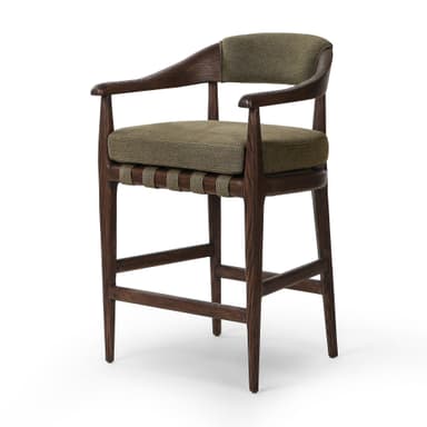 A bar stool with a wooden frame and upholstered seat and backrest. The frame is constructed from dark wood with visible grain. The seat and backrest are upholstered in a textured, olive-green fabric. The stool has a curved backrest that extends to armrests, and its legs are supported by crossbars. — 3D model
