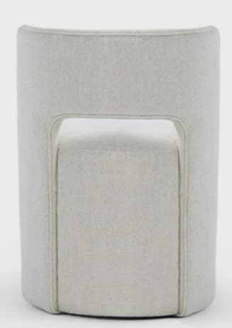A contemporary fully upholstered barrel-shaped chair featuring a distinct curved back with a central rectangular cutout, covered in a light beige or off-white textured fabric. — 3D model