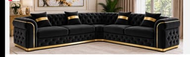 An L-shaped sectional sofa featuring deep button-tufted black velvet upholstery with prominent gold metal accents along the base and armrests. The design incorporates rolled arms, characteristic of a Chesterfield style, and includes several decorative throw pillows with a gold band design. — 3D model
