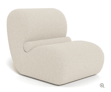 A modern armchair with a low profile and rounded edges, upholstered in a textured fabric. It features a continuous form for the seat and backrest, with a subtle horizontal division in the backrest. The overall design is minimalist and inviting. — 3D model