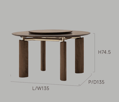 A contemporary round dining table crafted from dark-stained wood. It features a circular main tabletop with a smaller, rotating circular tray (Lazy Susan) embedded in its center. The table stands on four thick, cylindrical wooden legs, which are connected to the tabletop with subtle brass-toned metal fixtures, providing both structural support and a decorative accent. — 3D model