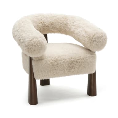 A plush, cream-colored armchair with a rounded, sculptural backrest and arms, upholstered in a shaggy faux fur. The chair is supported by four dark brown, tapered wooden legs that flare slightly outwards. Dimensions are indicated: 31.9"H x 31.2"W x 28.4"D, with seat height at 20.5"H. — 3D model