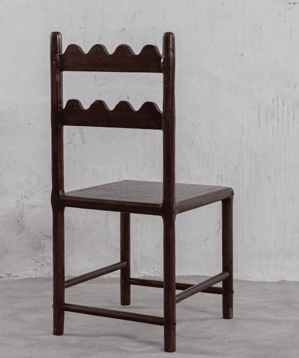 A dark-stained wooden chair featuring a distinctive backrest with two horizontal slats, each carved with a wavy or scalloped edge. It has a simple square wooden seat and straight legs with stretchers. — 3D model