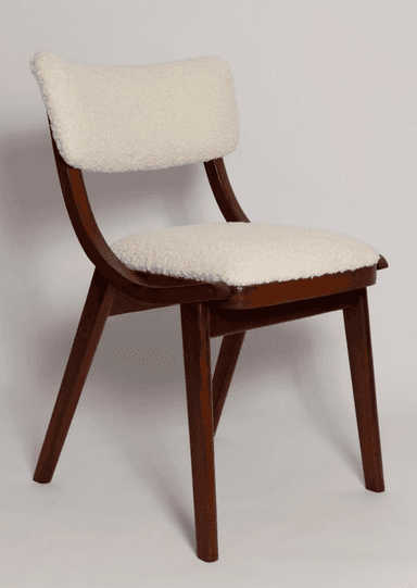 A contemporary armless chair featuring a dark brown wooden frame and a plush, cream-colored boucle upholstered seat and backrest. The design incorporates graceful curves in the back supports and subtly tapered legs. — 3D model