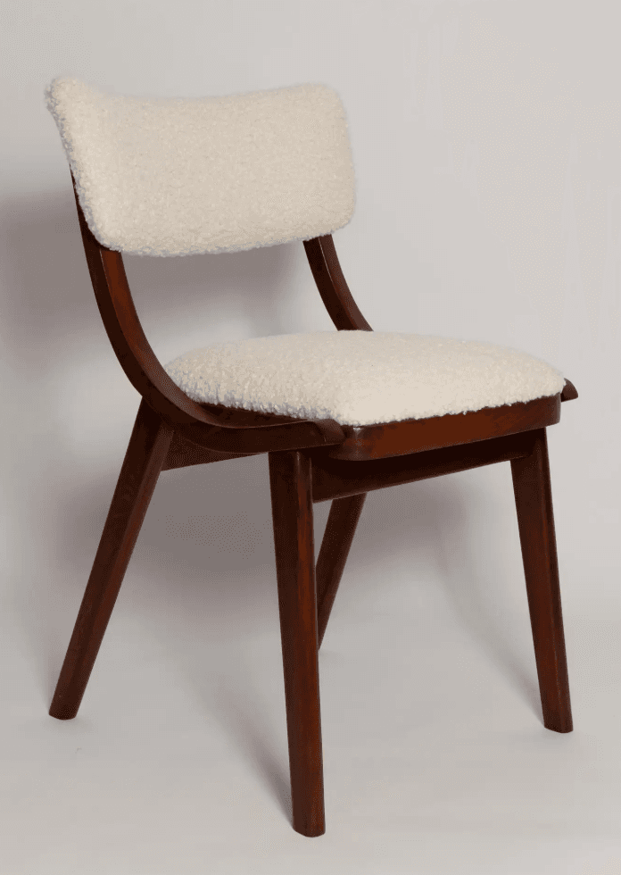 A contemporary armless chair featuring a dark brown wooden frame and a plush, cream-colored boucle upholstered seat and backrest. The design incorporates graceful curves in the back supports and subtly tapered legs. — 3D model
