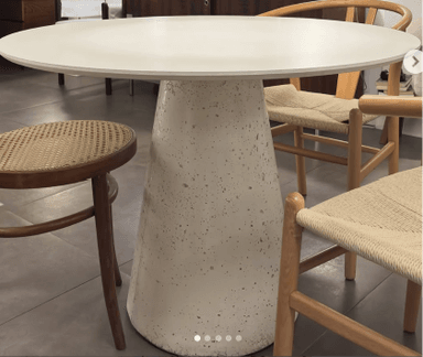 A light grey, round pedestal table with a conical base and a speckled concrete-like finish. — 3D model