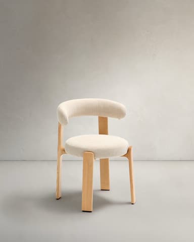A contemporary armchair featuring a light wood frame and cream-colored upholstered seat and backrest. The design is minimalist with rounded forms, including a circular seat and a curved backrest that seamlessly integrates with the armrests. The legs are sturdy, splayed outwards slightly, and match the natural wood tone. — 3D model