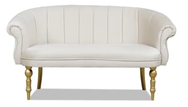 A stylish small loveseat or settee featuring a gracefully curved backrest with vertical channel tufting, rolled armrests, and an upholstered seat. The piece is supported by four golden-finished, turned wooden legs, with the front legs exhibiting a more elaborate design compared to the simpler tapered rear legs. The upholstery appears to be a soft, light-colored fabric, possibly velvet or a similar plush material. — 3D model