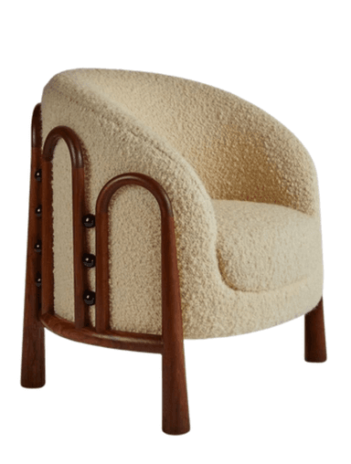 A contemporary accent armchair featuring a rounded, upholstered body covered in a cream-colored, textured boucle-like fabric. The chair has exposed dark wood elements that form the armrests and extend downwards to become the tapered legs. The design emphasizes soft curves and a minimalist aesthetic. — 3D model