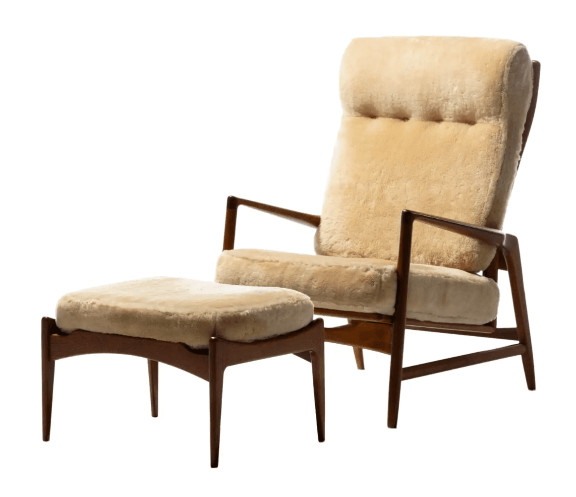 A mid-century modern armchair with a matching ottoman. The armchair features a high back and armrests constructed from dark wood, with upholstered seat, back, and headrest in a plush, light beige shearling fabric. The ottoman has a similar wooden base and a shearling upholstered top. The wooden frame exhibits a streamlined, organic design typical of Scandinavian modernism. — 3D model