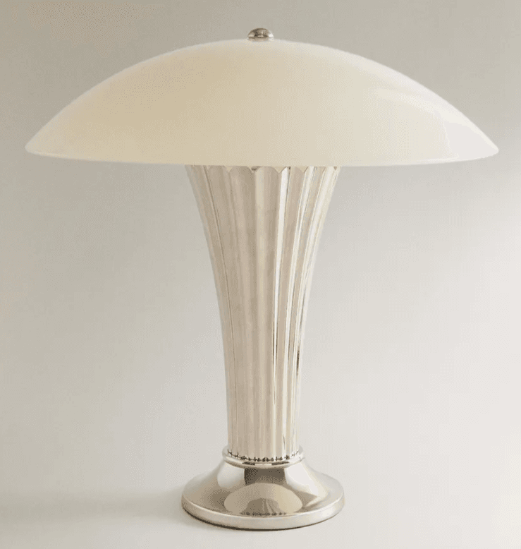 A polished metallic table lamp featuring a ribbed or fluted stem and base, topped with a domed, opaque off-white shade. The design suggests an Art Deco influence. — 3D model