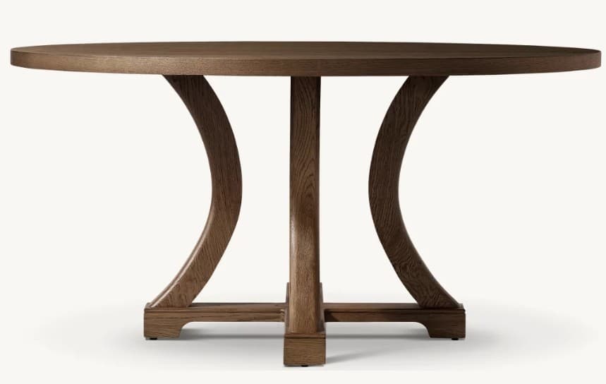 A round wooden table with a distinctive pedestal base featuring four central support columns that branch into two large opposing curved elements, all resting on a sturdy square-shaped footed base. — 3D model