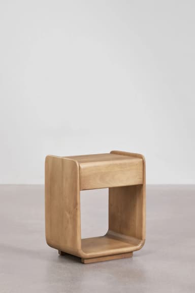 A modern, cube-shaped nightstand with rounded edges and an open compartment. The piece is constructed from solid wood and exhibits a natural grain pattern. It rests on a small, subtle base. — 3D model