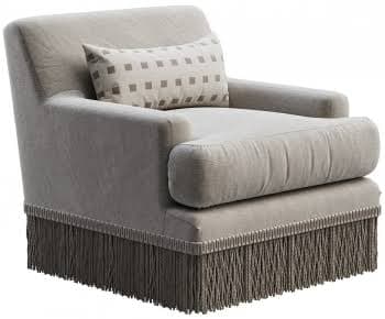 A modern upholstered armchair, featuring plush, rounded arms and backrest, a distinctive rolled front seat cushion, and a long, decorative fringe skirt along the base. It is presented in a light neutral fabric and includes a small rectangular lumbar pillow with a geometric pattern. — 3D model
