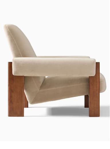 A modern armchair with a wooden frame and upholstered cushions. The armchair features a high backrest, wide armrests, and a supportive seat. The frame is constructed from solid wood, showcasing a natural finish. The upholstery is a soft, neutral-toned fabric, likely velvet or a similar plush material. — 3D model