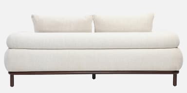 A contemporary loveseat upholstered in off-white bouclé fabric, featuring a plush, rounded design, broad armrests, and a recessed dark wood base with short, cylindrical legs. — 3D model