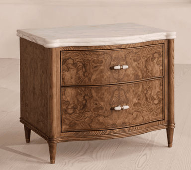 A two-drawer nightstand with a marble top. The main body of the nightstand is constructed from wood with a distinctive burl veneer on the drawer fronts. The drawer fronts are curved and feature two rectangular pulls with white inserts and brass accents. The nightstand is supported by four tapered legs, also with brass ferrules at the base. — 3D model