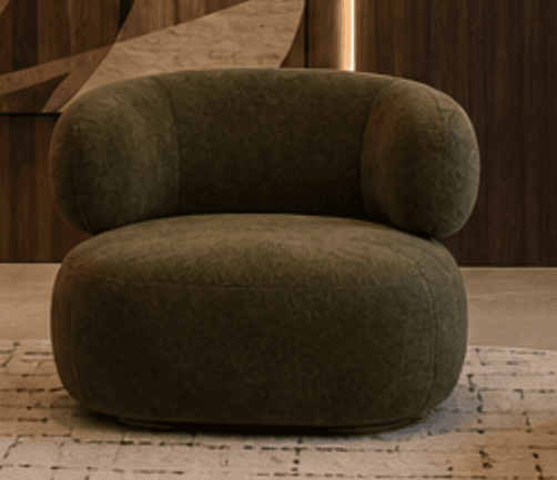 A contemporary lounge chair featuring a soft, plush olive green textured upholstery. The chair has a distinctive rounded, enveloping silhouette with a curved backrest that seamlessly integrates with the armrests. The base is also rounded, contributing to the overall soft and organic form of the piece. It appears to be a single, cohesive upholstered unit designed for comfort. — 3D model