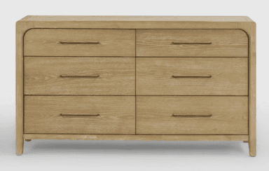 A rectangular six-drawer dresser made from light-toned oak wood with prominent grain. It features softly rounded vertical corners on the frame, and minimalist dark metal bar pulls on each drawer. The dresser stands on short, integrated legs. — 3D model