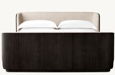 A modern platform bed featuring a dark wood frame with distinct graining and gently curved corners. The headboard is integrated, upholstered in a light, neutral fabric, and extends along the sides, enveloping the sleeping area. The bed has a low-profile base, suggesting a platform design that does not require a box spring. White bedding is present, indicating its function. — 3D model