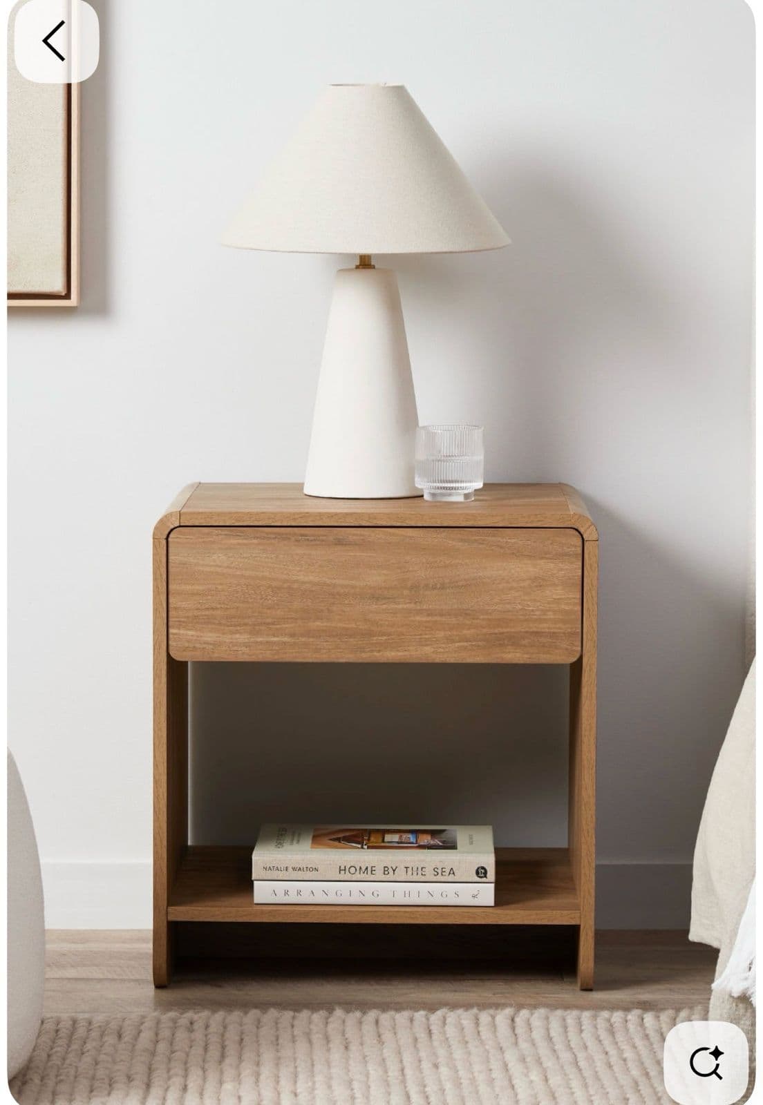 A minimalist wooden nightstand featuring a single drawer at the top and an open lower shelf, characterized by softly rounded corners and a natural wood finish. — 3D model