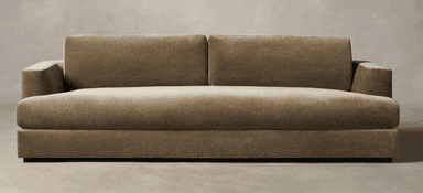 A contemporary two-seater sofa upholstered in a plush, olive green velvet or similar fabric, featuring a low-profile design, track arms, two distinct loose back cushions, and a single, long seat cushion. The sofa rests on discreet, recessed block feet, giving it a floating appearance. — 3D model