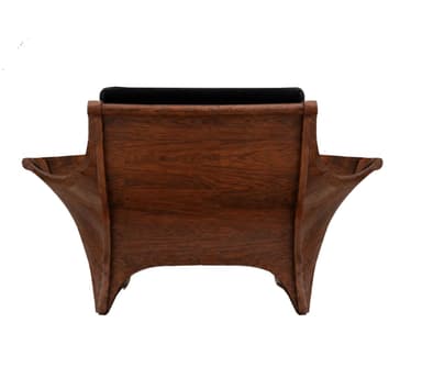 A sculptural lounge chair featuring a dark, richly-grained wood frame with sweeping, organic curves, paired with thick black velvet upholstery. The chair's design is low-slung and wide, emphasizing comfort and a relaxed posture. The backrest and seat cushions are distinct and plush, providing a soft contrast to the hard wooden shell. The frame's continuous lines form the arms and base, giving it a seamless, integrated appearance. — 3D model