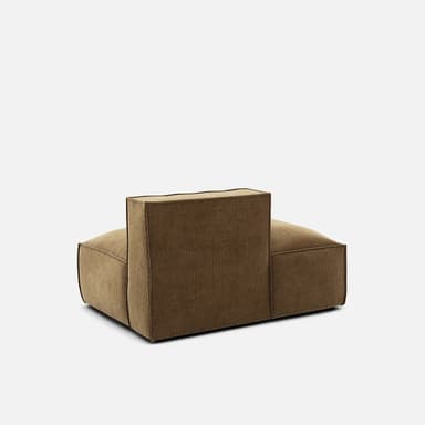 A modular sofa section with a low profile and plush cushioning. It features a single armrest or back support rising vertically from the seat, with a distinct seam line around the perimeter of the base and the seat cushion. The upholstery appears to be a textured fabric with a ribbed pattern. — 3D model