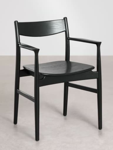 A modern black-stained wooden armchair with a minimalist design, featuring a gently curved backrest, integrated armrests, and a solid wood seat. The chair's legs are slightly tapered, contributing to its sleek aesthetic. — 3D model