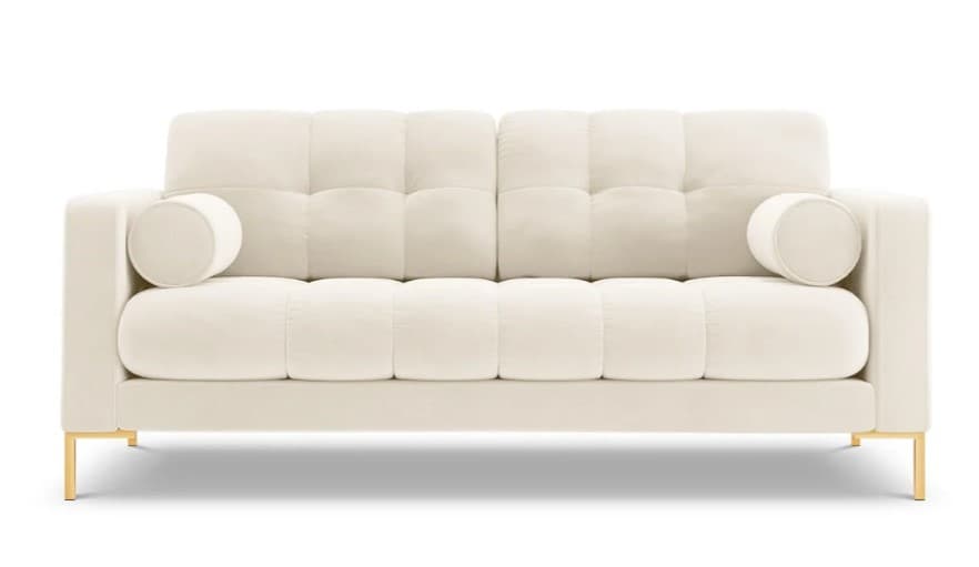 A contemporary two-seater loveseat upholstered in ivory-colored velvet fabric, featuring deep square tufting on both the backrest and seat cushions. It has straight track arms and is accompanied by two matching cylindrical bolster pillows. The loveseat is supported by slender, rectangular legs with a polished gold finish, creating a modern and elegant aesthetic. — 3D model