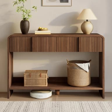 A contemporary console table constructed from rich dark walnut wood, characterized by its elongated, narrow form. The design features a smooth, rounded top surface and solid side panels that descend to the floor. The upper section of the front facade showcases distinctive reeded detailing, concealing two integrated storage compartments or drawers. A full-width open shelf is positioned below the upper storage, providing additional display or storage space. — 3D model