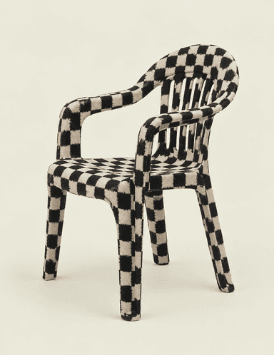 A molded plastic armchair covered in a fuzzy black and off-white checkered textile pattern. It features integrated armrests and a slatted backrest. — 3D model