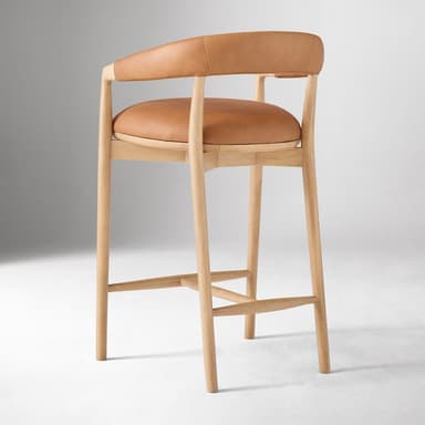 A bar stool with a curved backrest and armrests, featuring a wooden frame and leather upholstery for the seat and back. The frame consists of four cylindrical legs connected by stretchers for stability. The seat is flat and padded, while the backrest is also upholstered and curves to provide lumbar support. The armrests are integrated into the frame structure. — 3D model