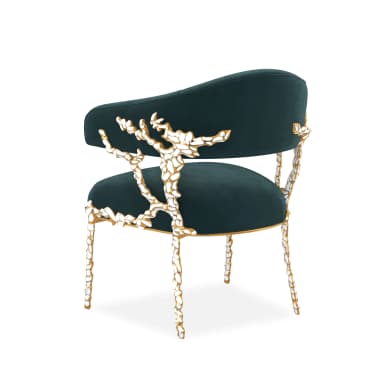 A luxurious barrel-style armchair upholstered in dark teal velvet, featuring an ornate frame with gold-finished metallic sections and sculptural white bone-like embellishments on the arm supports and slender legs. — 3D model
