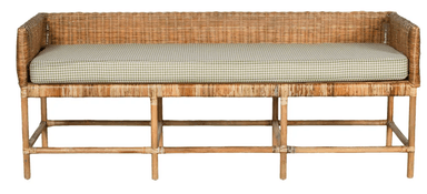 A long, rectangular bench featuring a woven rattan body with low, integrated armrests and a backrest. It is supported by a light-toned wooden or bamboo-style frame with horizontal and diagonal cross-supports. A light green and white checkered pattern cushion rests on the seating surface. — 3D model