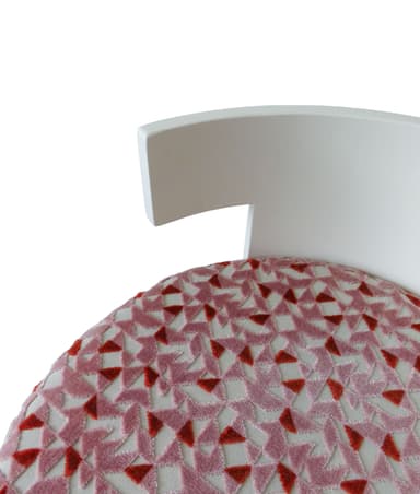 A contemporary cylindrical stool featuring a pink and red geometric patterned upholstery and a distinctive T-shaped white backrest. The base is fully upholstered with a textured fabric, while the backrest provides a clean, minimalist contrast in a solid color. — 3D model
