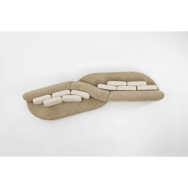 A contemporary curved modular sectional sofa featuring a beige upholstered base and lighter, off-white rectangular back cushions. The sofa consists of at least two large, organically shaped sections joined to form a fluid, undulating seating arrangement. — 3D model