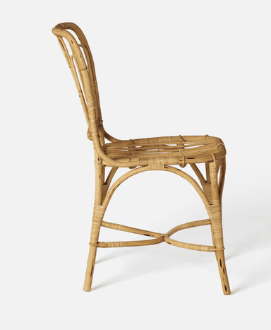 A vintage-style side chair constructed entirely from natural rattan. The chair features a curved backrest with vertical spindles and a woven seat. The legs are joined by a curved stretcher and a lower crossbar for stability. — 3D model