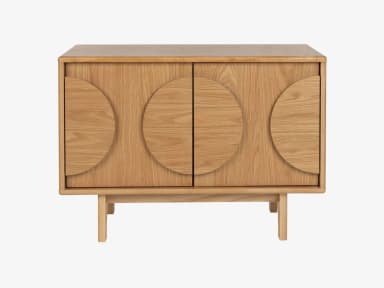A modern storage cabinet constructed from light-colored oak wood, featuring two doors with distinctive semi-circular carved handles that form a full circle when the doors are closed. The cabinet stands on four splayed, tapered legs. The design is clean and minimalist, highlighting the natural wood grain. — 3D model